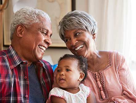 photo of a male and female senior with a baby